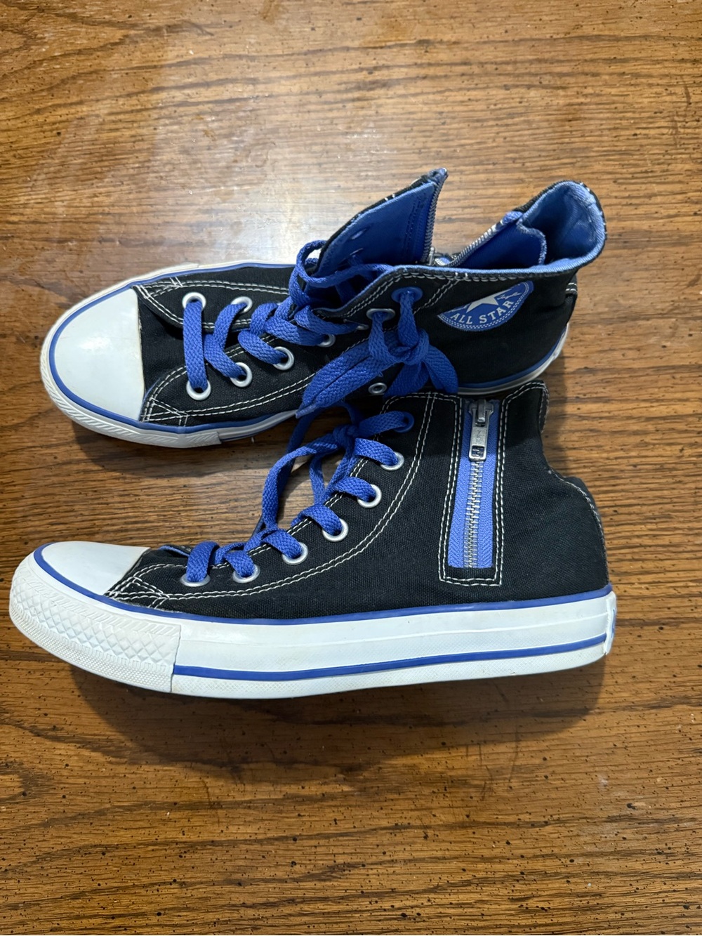 Converse Black Canvas High-Top Sneakers with Blue Laces and zippers.